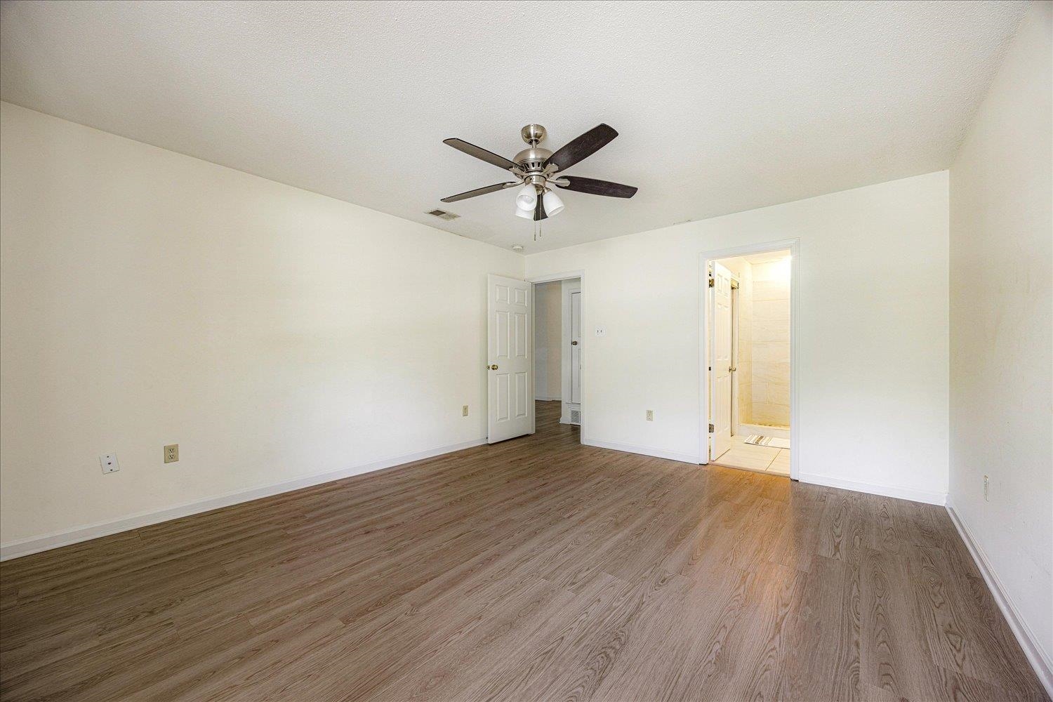 7944 Anne's Circle Memphis, TN 38018 - Photo 16 of 27 an empty room with wooden floor and ceiling fan