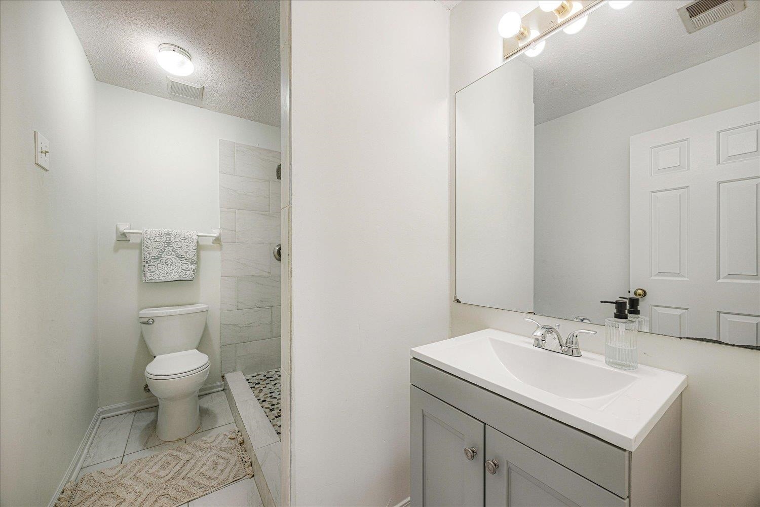 7944 Anne's Circle Memphis, TN 38018 - Photo 19 of 27 a bathroom with a sink toilet and a mirror