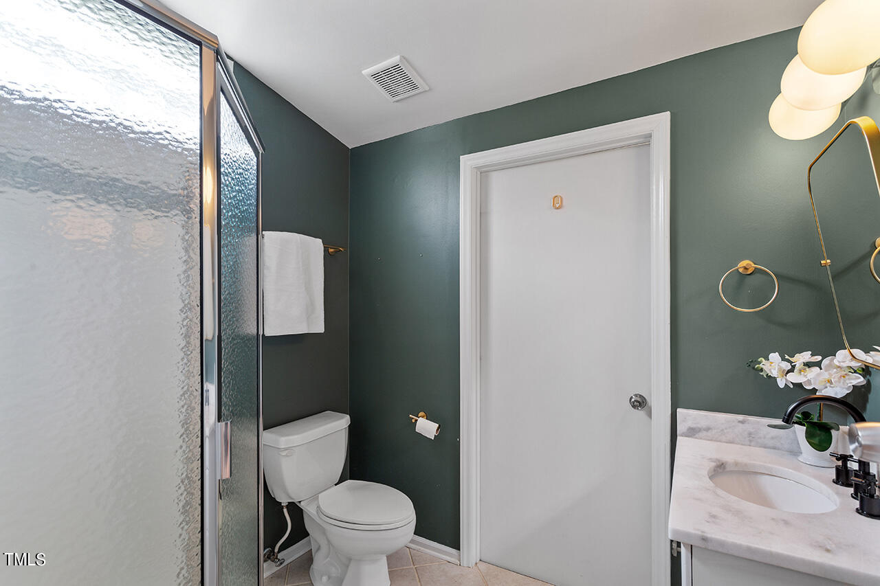 1607 Lorraine Road Raleigh, NC 27607 - Photo 25 of 37 Full bath off bedroom #2 with standing shower and updated vanity countertop and lighting.