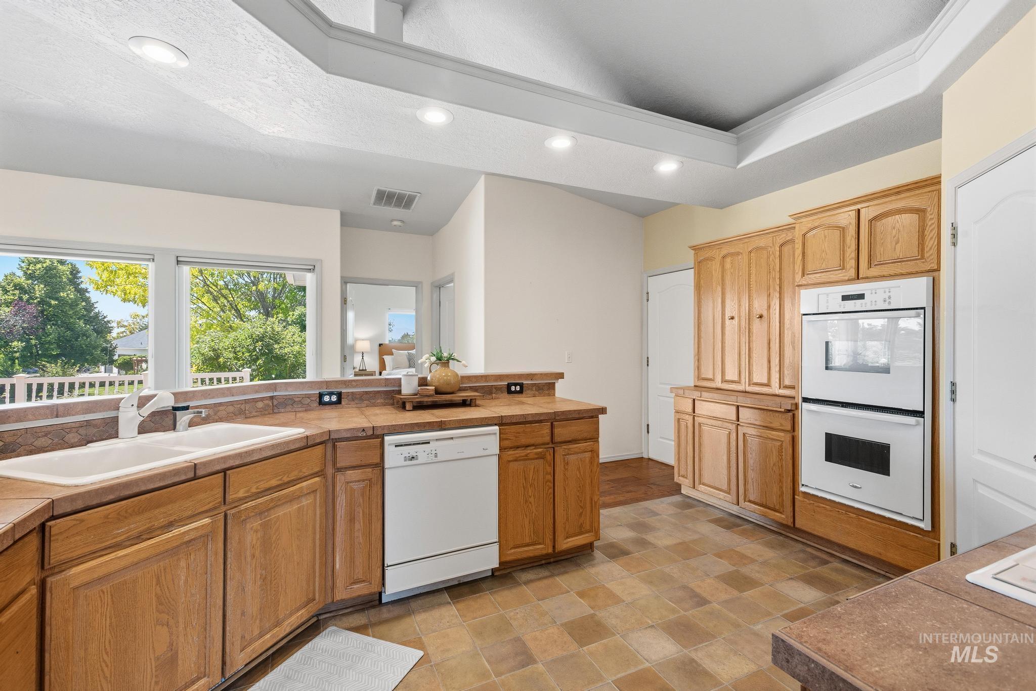 15181 Drury Way Caldwell, ID 83607 - Photo 17 of 49 Spacious kitchen with wood cabinetry, integrated double ovens, dishwasher, and a double basin sink