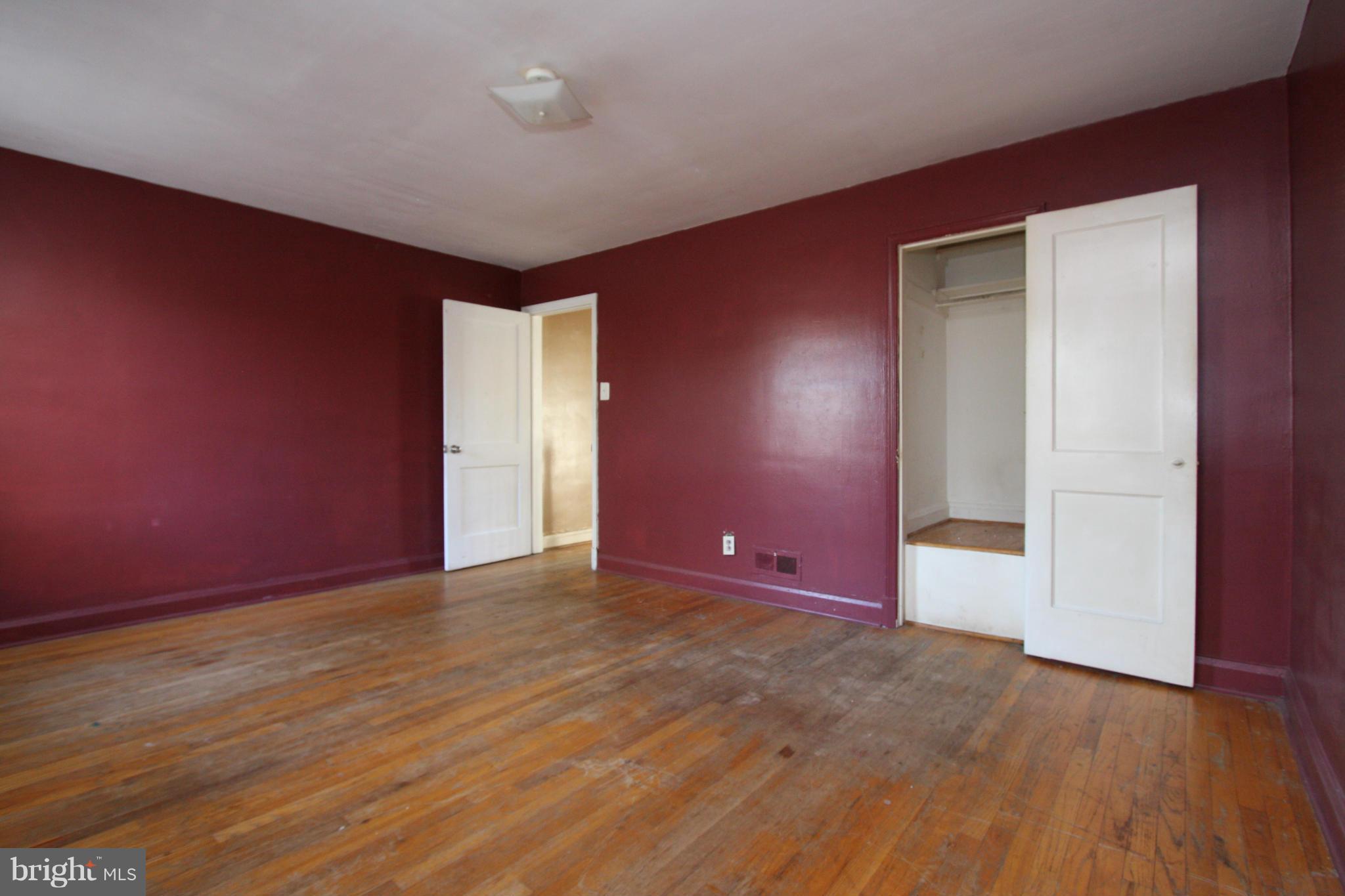 4407 Cedar Garden Road Baltimore, MD 21229 - Photo 13 of 30 an empty room with wooden floor and windows