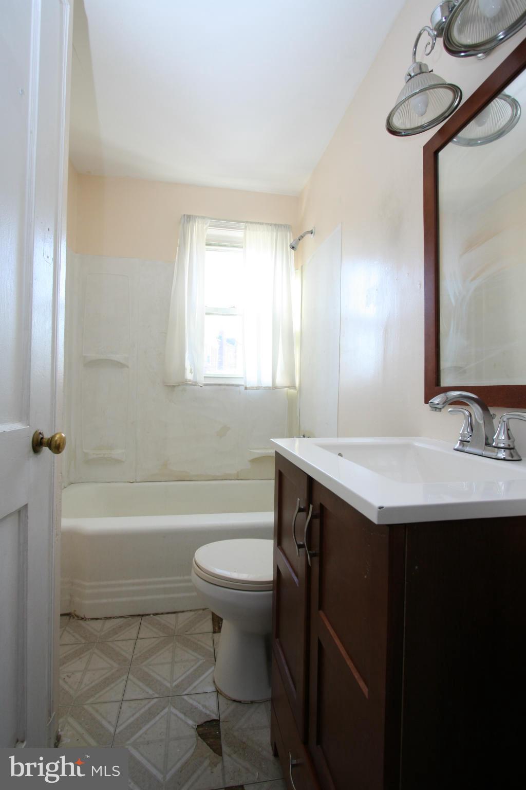 4407 Cedar Garden Road Baltimore, MD 21229 - Photo 18 of 30 a bathroom with a sink a toilet and bathtub