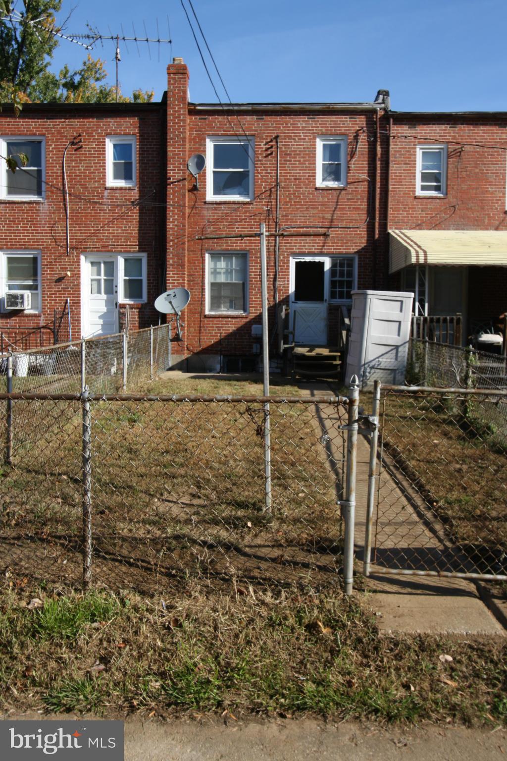 4407 Cedar Garden Road Baltimore, MD 21229 - Photo 25 of 30 front view of a brick house with a yard