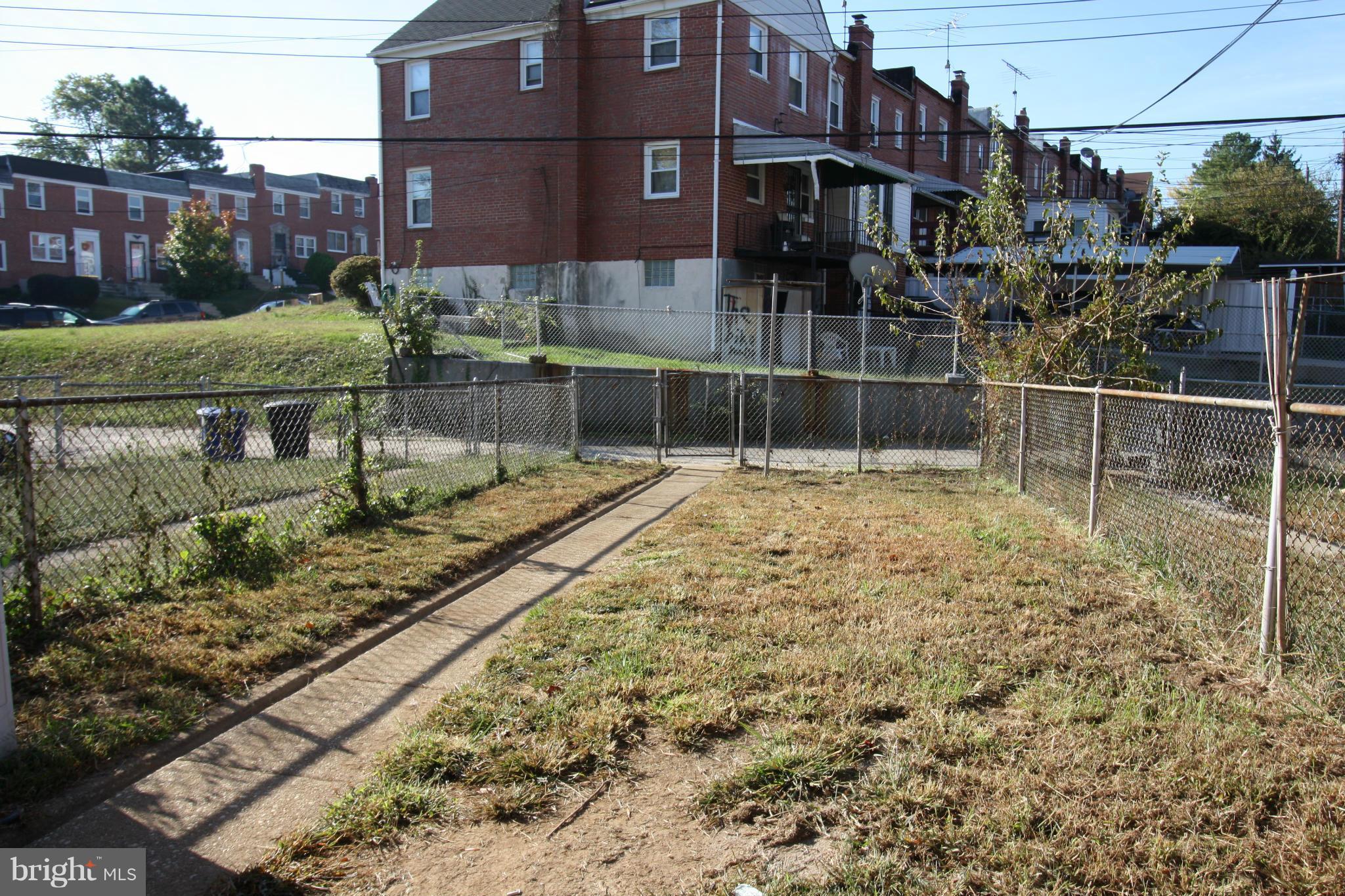 4407 Cedar Garden Road Baltimore, MD 21229 - Photo 28 of 30 a view of a brick house with a yard
