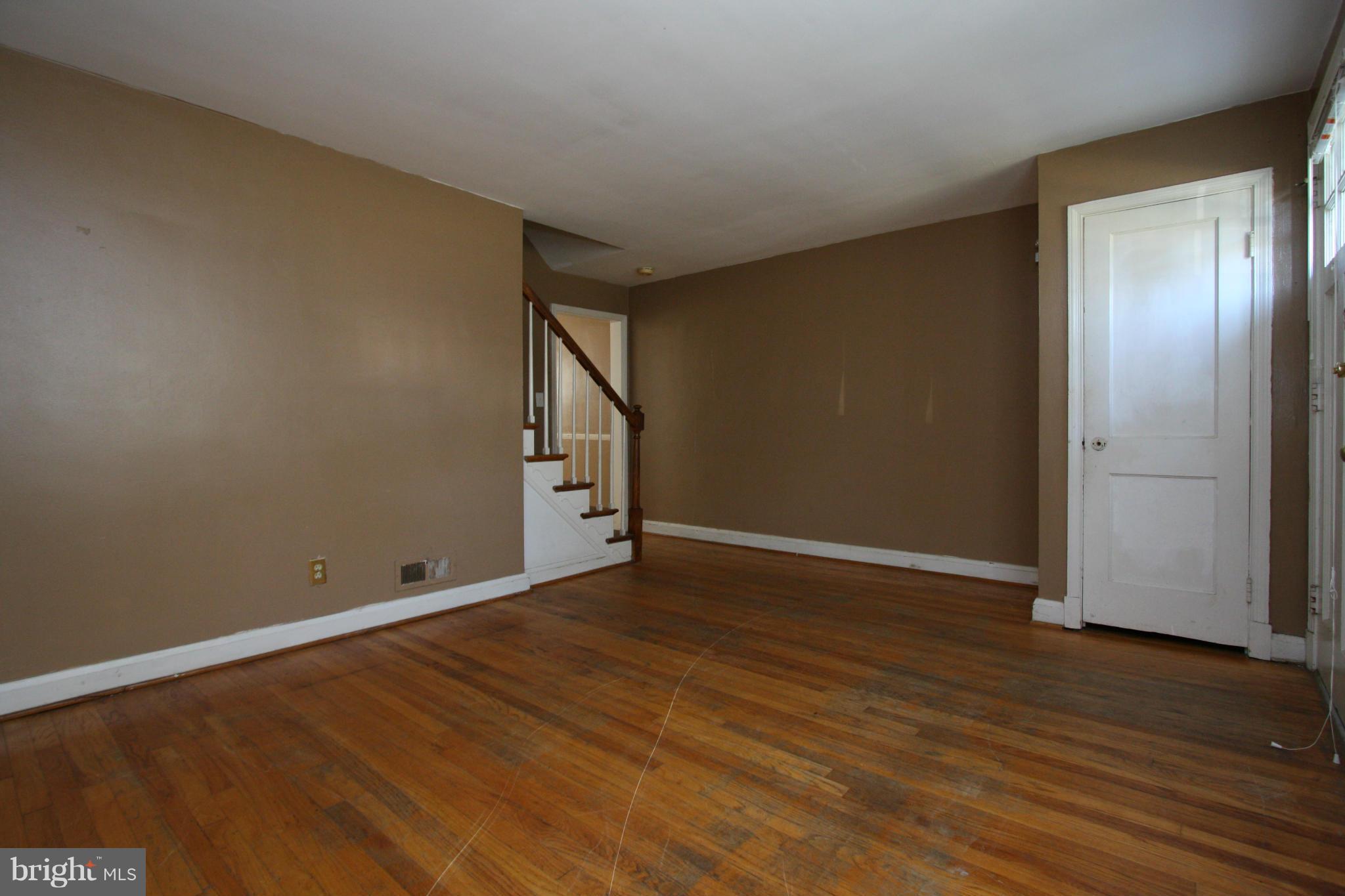 4407 Cedar Garden Road Baltimore, MD 21229 - Photo 6 of 30 a view of an empty room with wooden floor and a window
