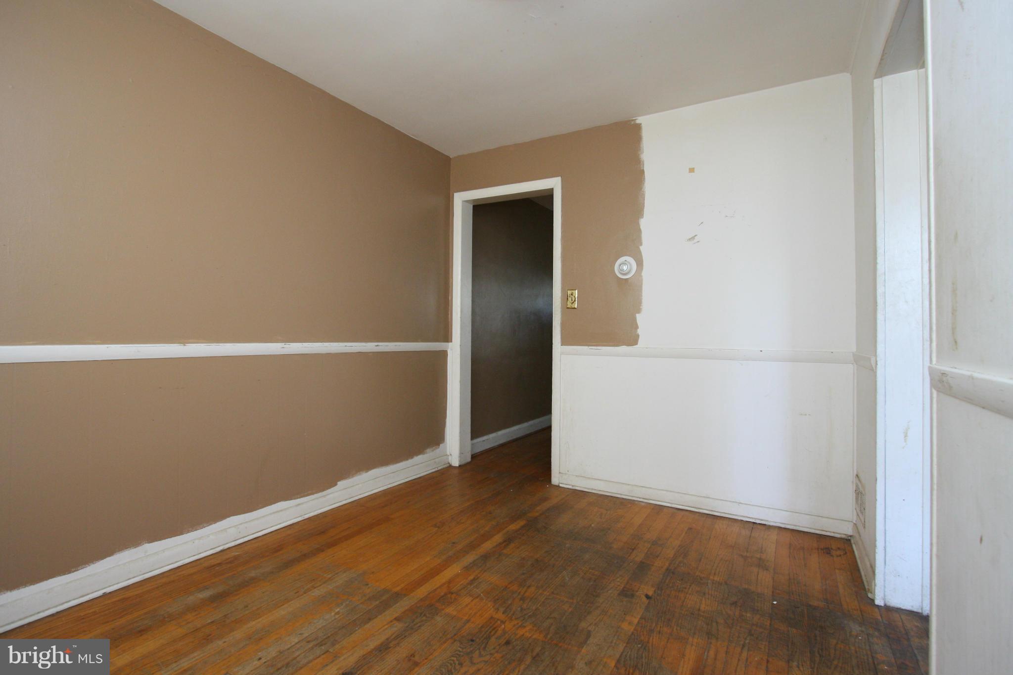 4407 Cedar Garden Road Baltimore, MD 21229 - Photo 8 of 30 an empty room with wooden floor