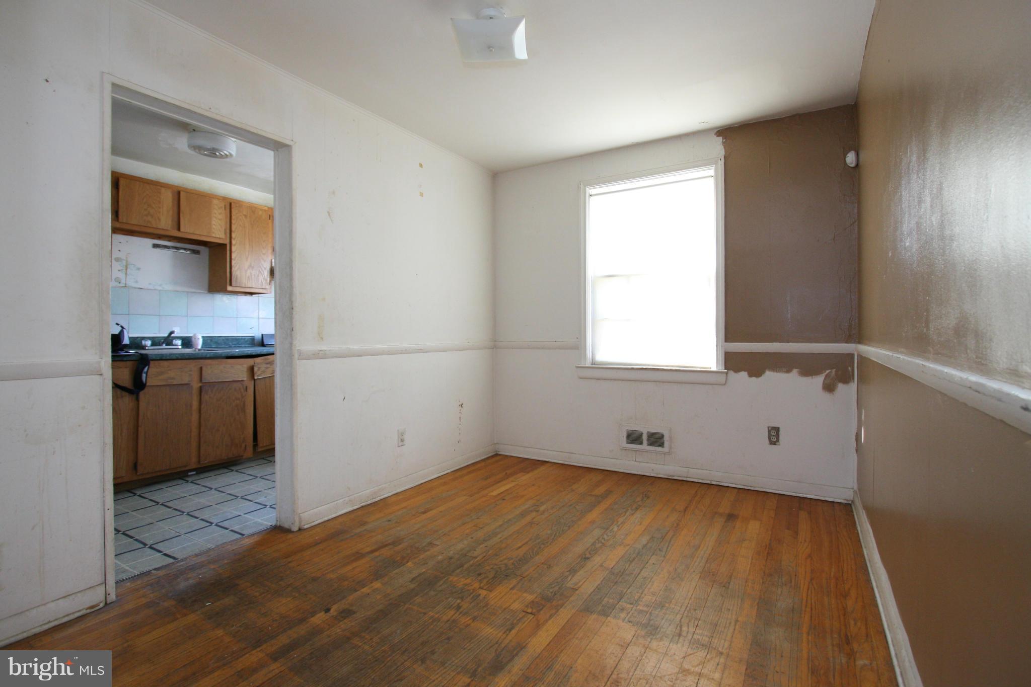 4407 Cedar Garden Road Baltimore, MD 21229 - Photo 9 of 30 a view of empty room with window and wooden floor