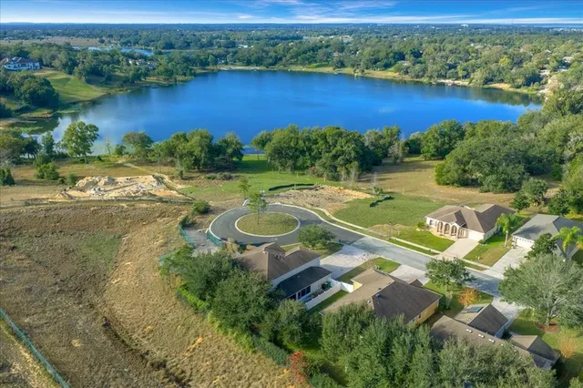 an aerial view of residential houses with outdoor space and river