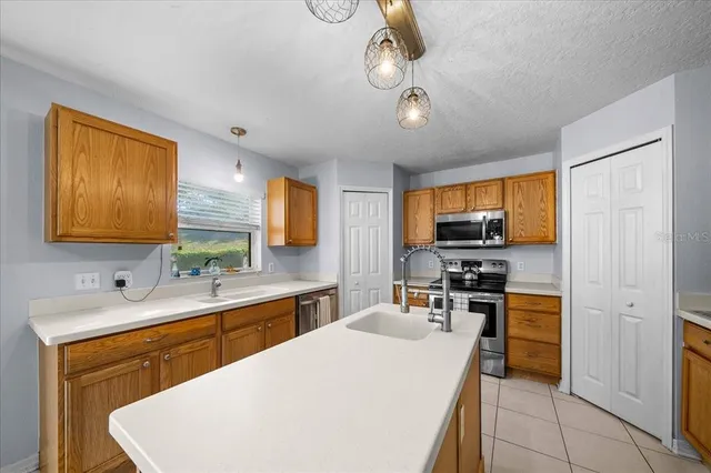 a spacious bedroom with a bed and a chandelier