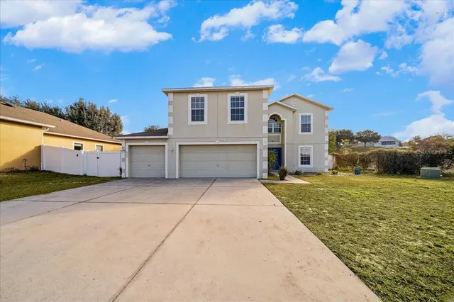 a view of a white house with a yard