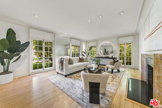 a living room with furniture a window and a fireplace