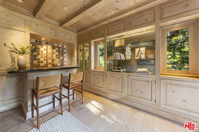 a view of a room with wooden floor and windows