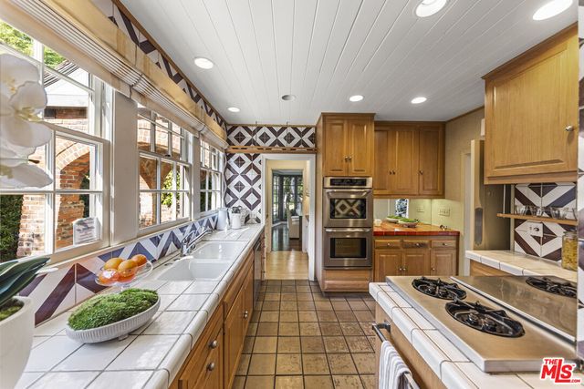 a kitchen with stainless steel appliances granite countertop a stove and a refrigerator