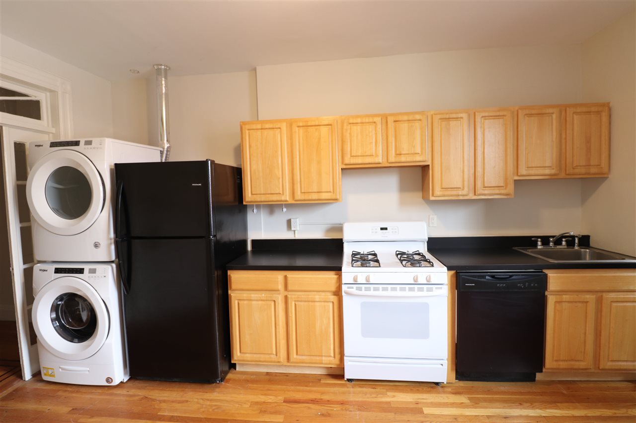 a kitchen with a stove and a refrigerator