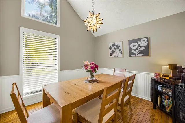 a view of a dining room with furniture wooden floor and a chandelier