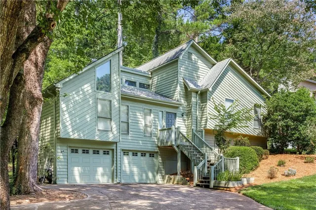 a front view of a house with a garden