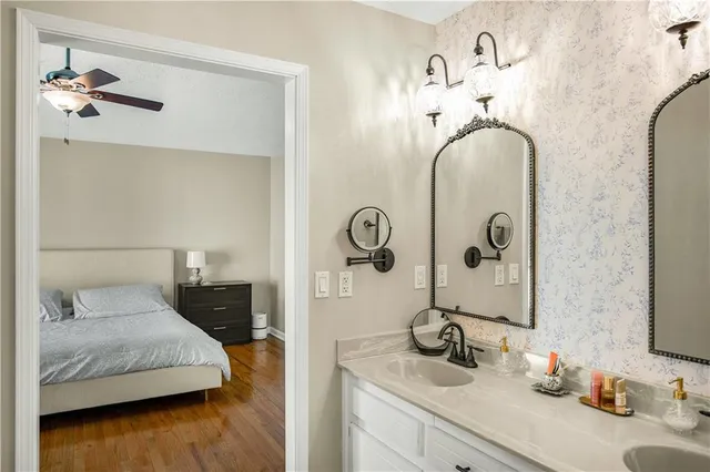 a en suite bathroom with a double vanity sink and a mirror