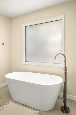 a white tub sitting next to a shower