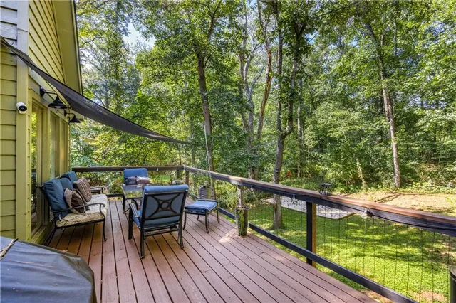 a view of a balcony with chairs and wooden floor