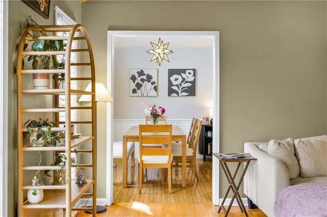 a view of a dining room with furniture and wooden floor
