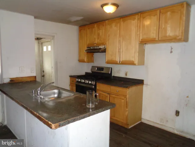 a kitchen with granite countertop cabinets and window
