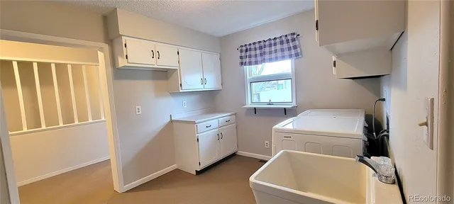 a utility room with cabinets dryer and washer
