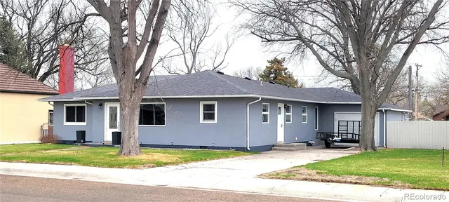 a house that has a tree in front of it
