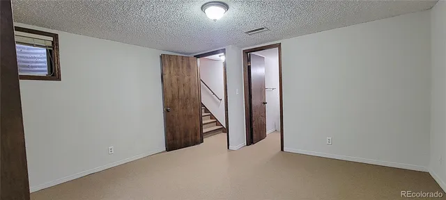 a view of a yard in front of a house with large tree