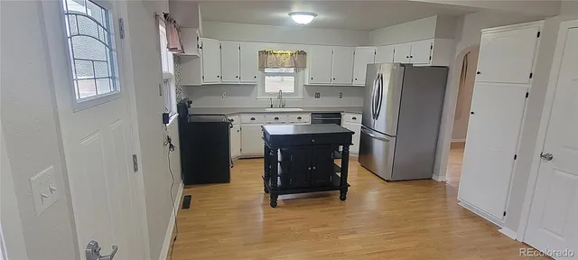 a kitchen with stainless steel appliances a refrigerator and a stove