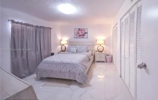 a bedroom with a bed and a table