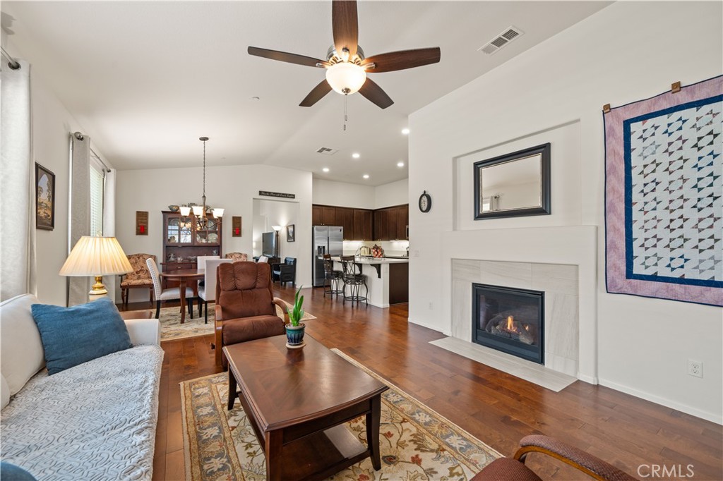 26519 Rim Creek Path Menifee, CA 92584 - Photo 12 of 45 a living room with furniture a table and a fireplace