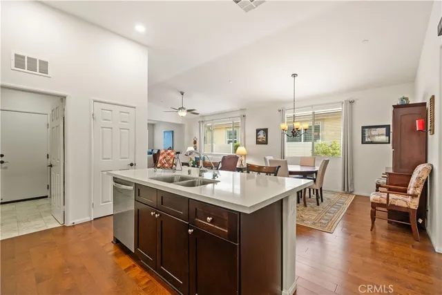 a kitchen with a sink stove and wooden floor
