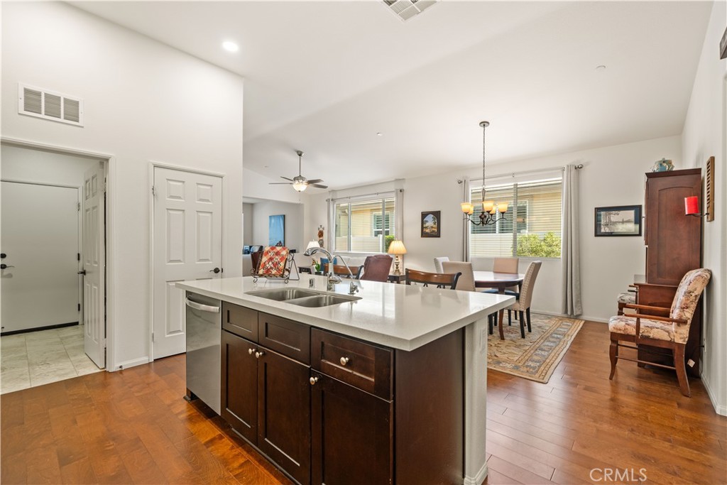 26519 Rim Creek Path Menifee, CA 92584 - Photo 21 of 45 a kitchen with a sink stove and wooden floor