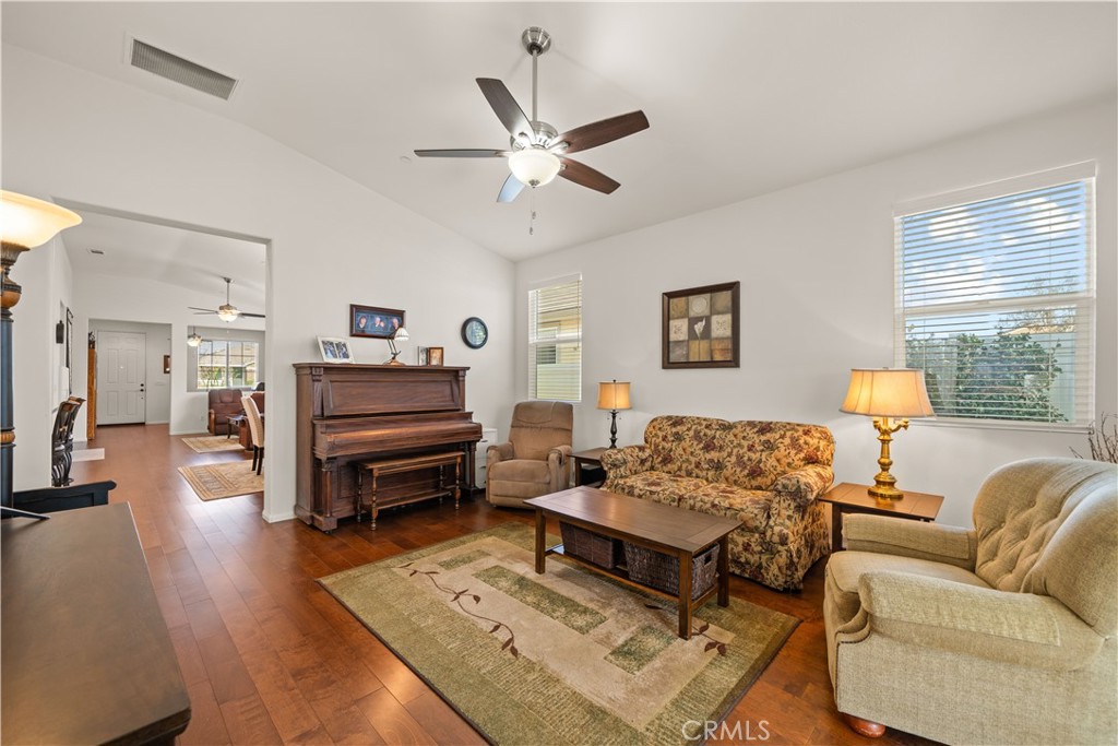 26519 Rim Creek Path Menifee, CA 92584 - Photo 24 of 45 a living room with furniture and a wooden floor