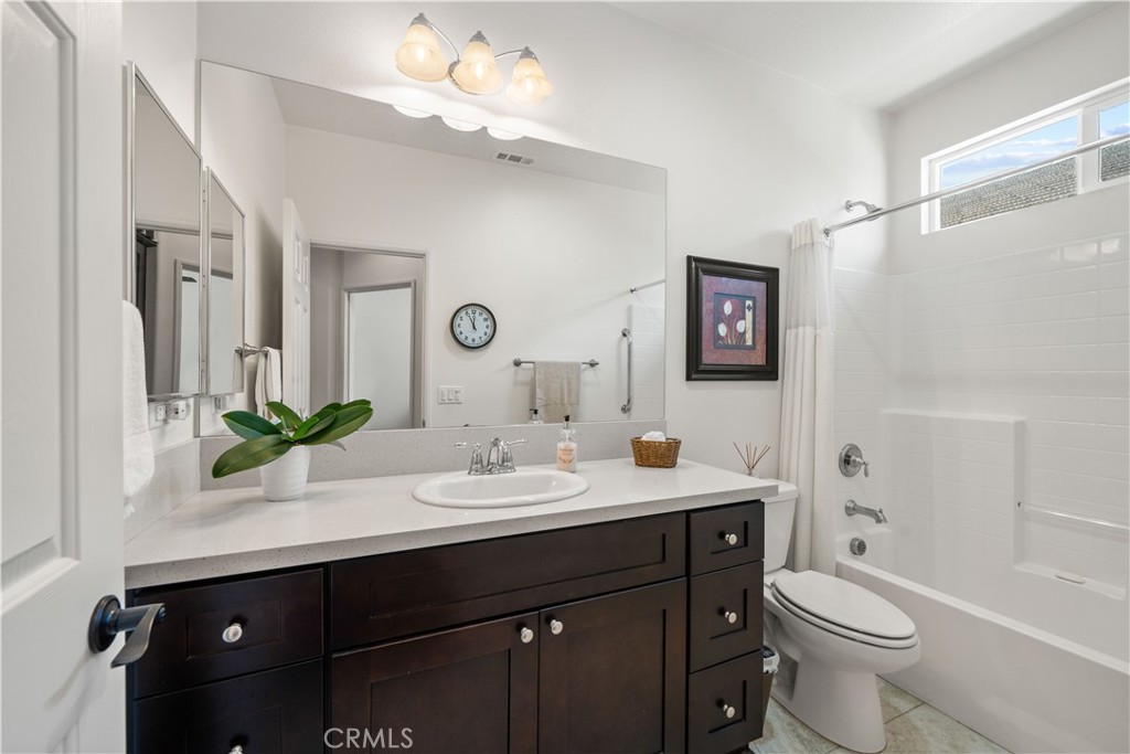 26519 Rim Creek Path Menifee, CA 92584 - Photo 31 of 45 a bathroom with a double vanity sink mirror and toilet