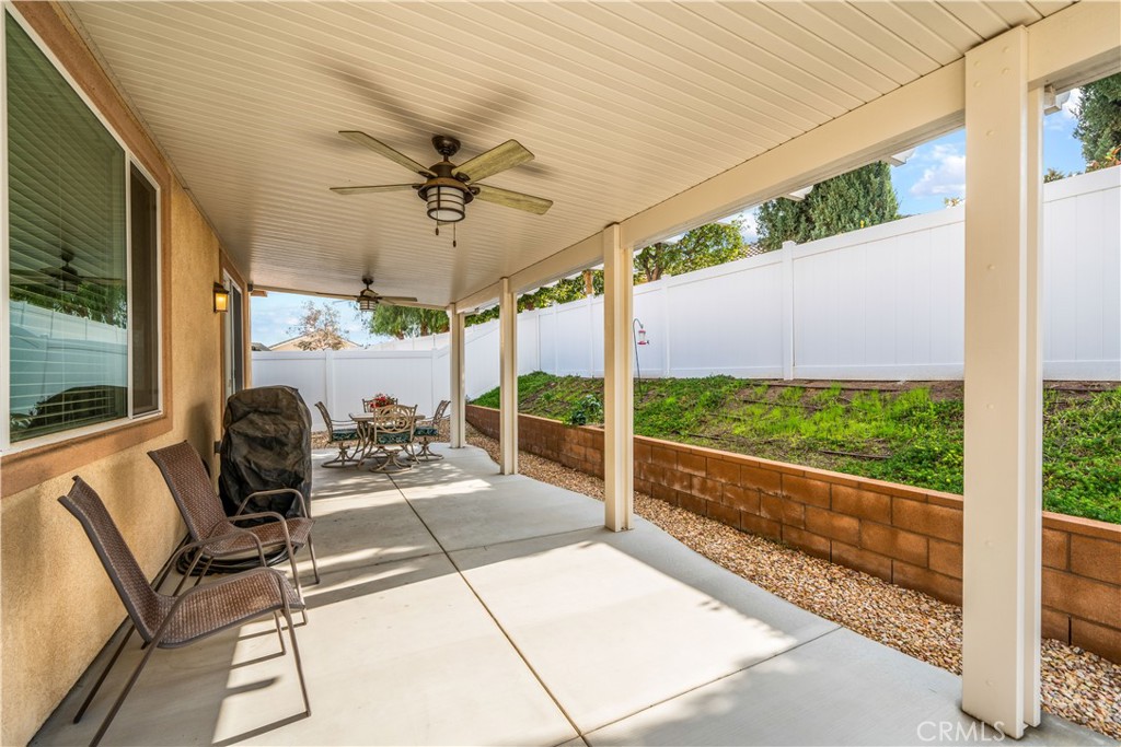 26519 Rim Creek Path Menifee, CA 92584 - Photo 35 of 45 a living room with hardwood floor and large windows