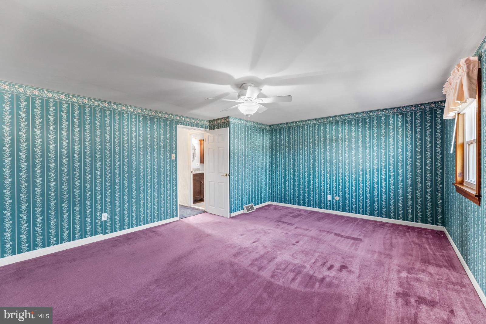 12423 Rambler Road Philadelphia, PA 19154 - Photo 18 of 46 en empty room with windows and a chandelier fan