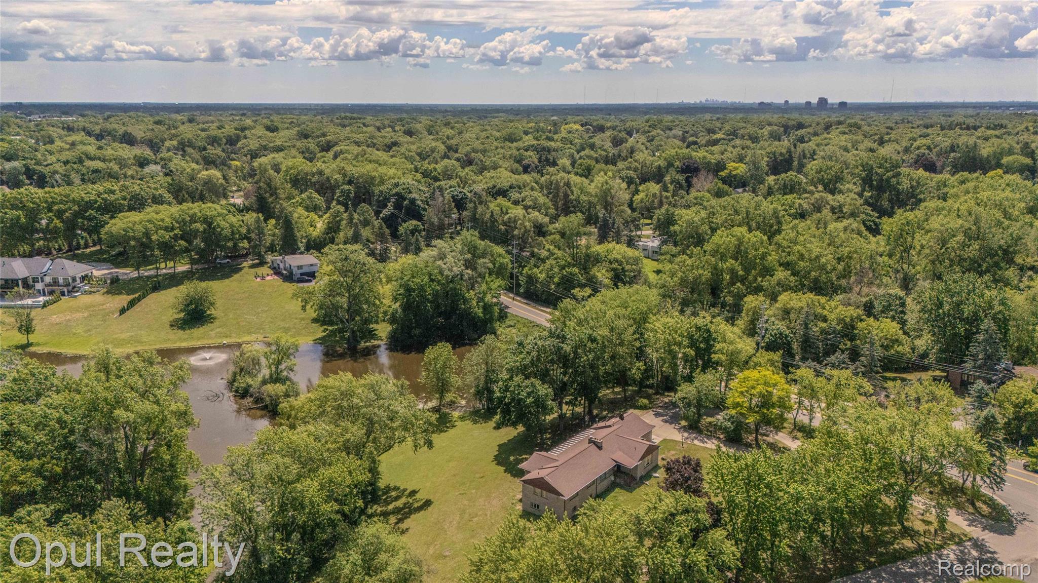 6455 Norham Road Bloomfield Hills, MI 48301 - Photo 86 of 93 Expansive property featuring a private pond with a fountain, surrounded by mature trees