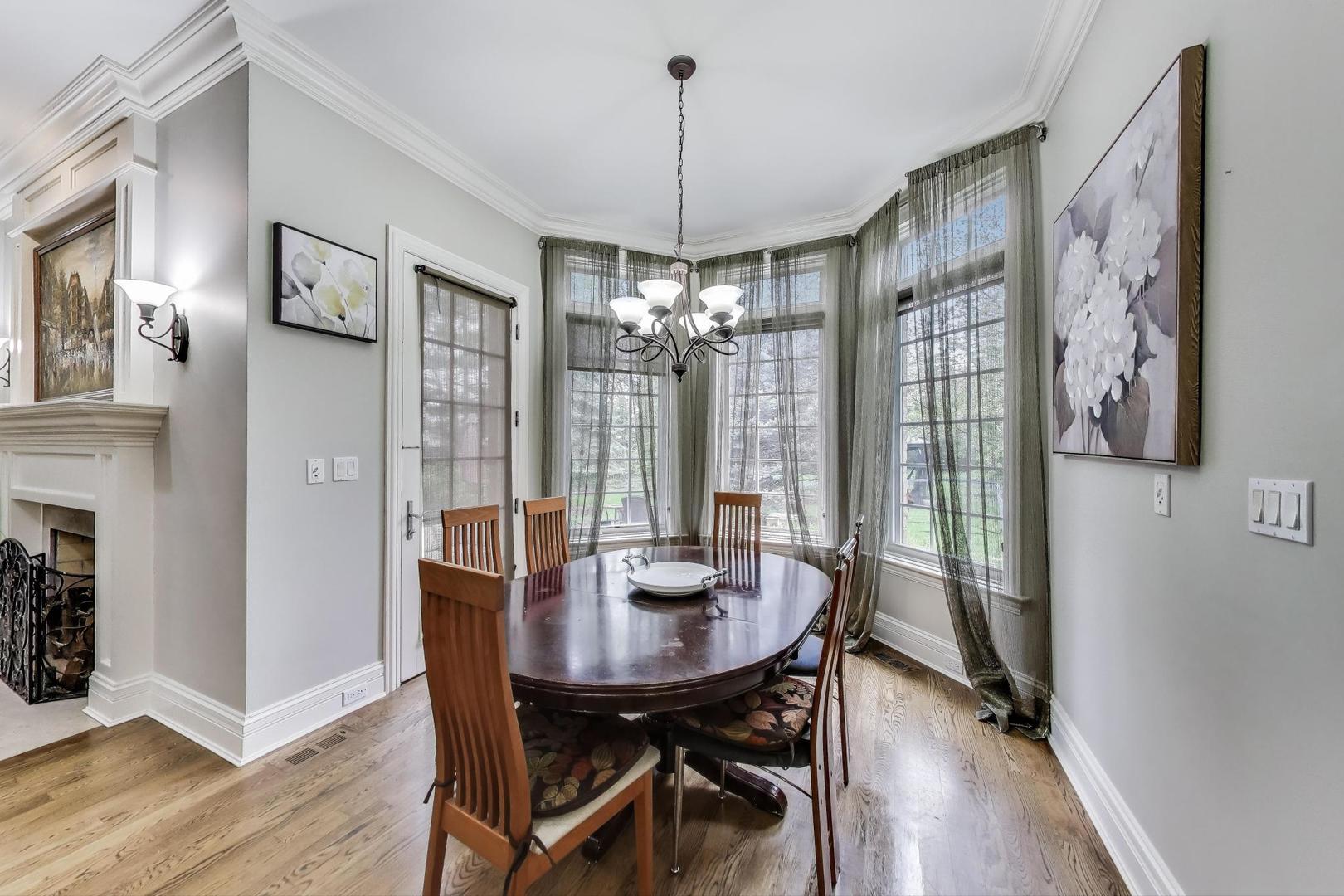 628 Greenwood Road Northbrook, IL 60062 - Photo 15 of 54 a view of a dining room with furniture window and wooden floor