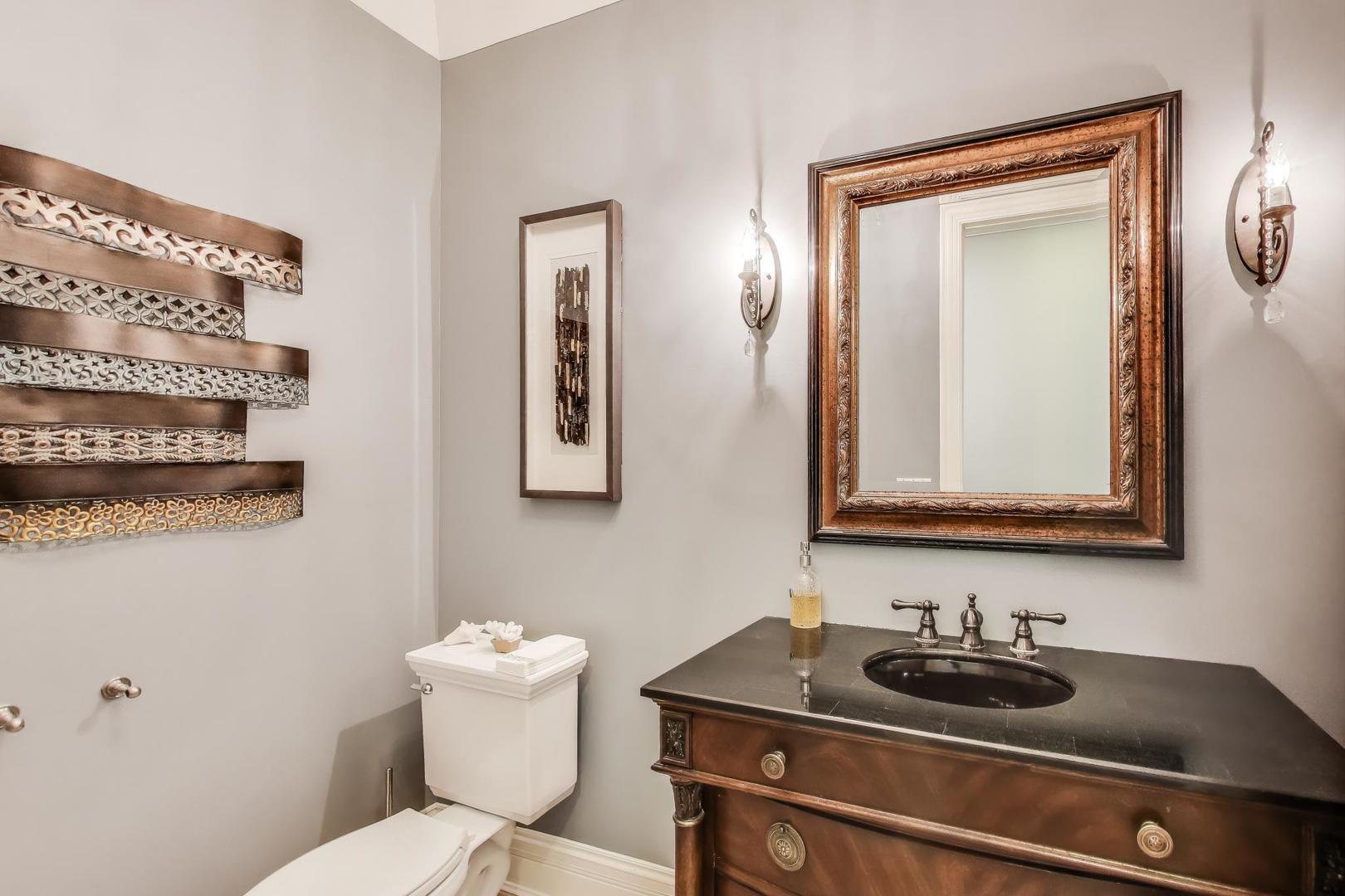 628 Greenwood Road Northbrook, IL 60062 - Photo 19 of 54 a bathroom with a toilet sink and mirror