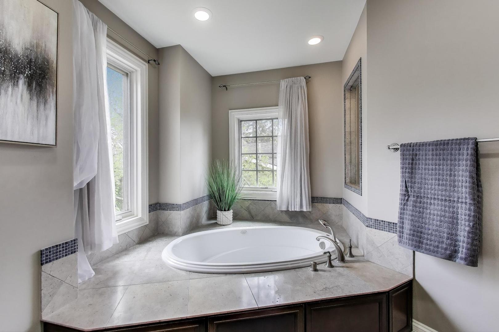 628 Greenwood Road Northbrook, IL 60062 - Photo 26 of 54 a bathroom with a granite countertop sink and a mirror