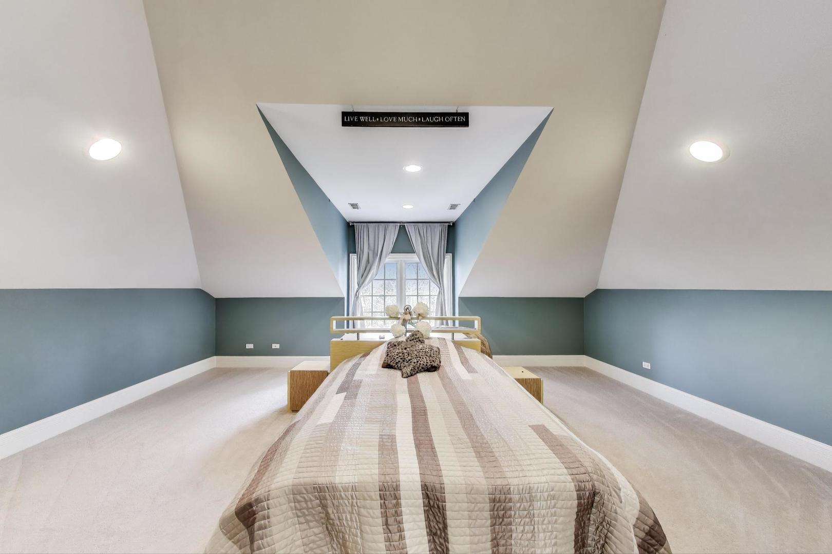 628 Greenwood Road Northbrook, IL 60062 - Photo 37 of 54 a bedroom with a bed and a chandelier