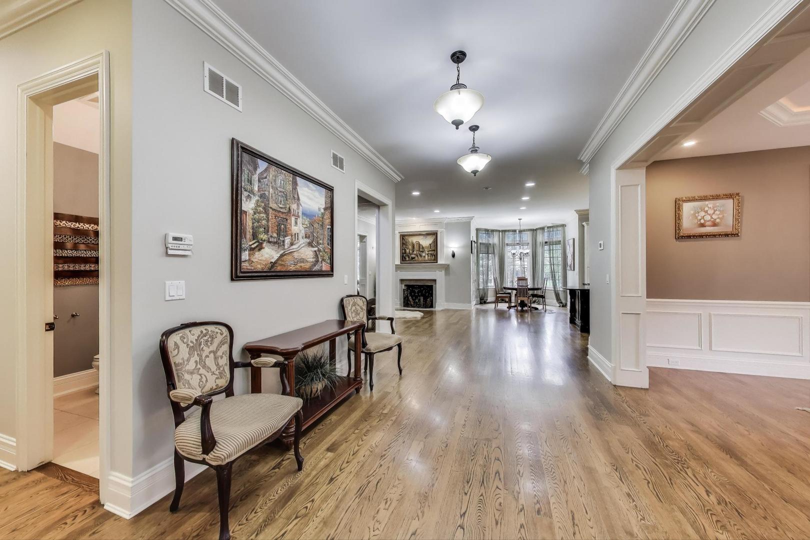 628 Greenwood Road Northbrook, IL 60062 - Photo 7 of 54 a view of a livingroom with furniture hardwood floor and a ceiling fan
