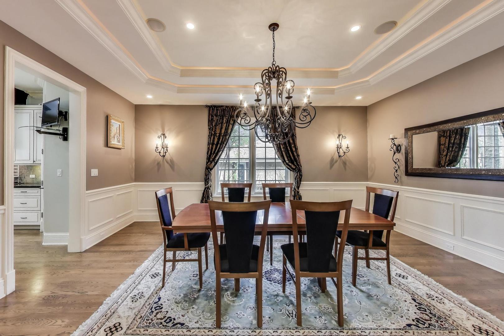 628 Greenwood Road Northbrook, IL 60062 - Photo 8 of 54 a view of a dining room with furniture a chandelier and wooden floor