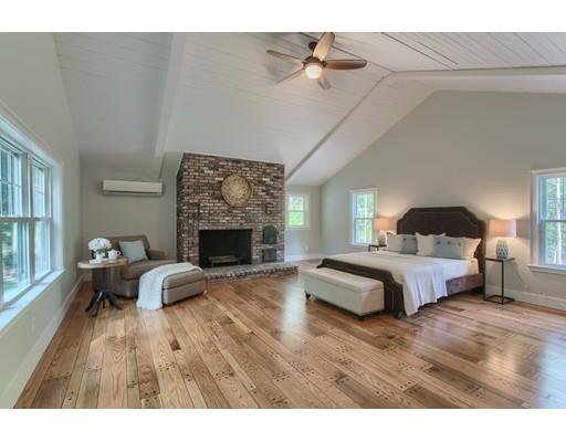 281 Hunters Ridge Road Concord, MA 01742 - Photo 14 of 26 a spacious bedroom with a bed and a fireplace