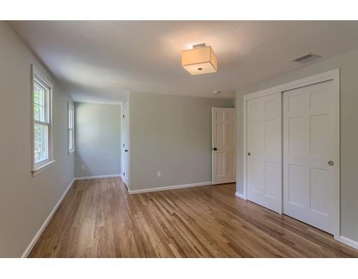 281 Hunters Ridge Road Concord, MA 01742 - Photo 17 of 26 a view of an empty room with wooden floor and window