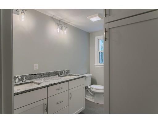 281 Hunters Ridge Road Concord, MA 01742 - Photo 18 of 26 a bathroom with a granite countertop sink a toilet and a mirror
