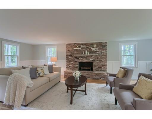 281 Hunters Ridge Road Concord, MA 01742 - Photo 3 of 26 a living room with furniture a fireplace and a table