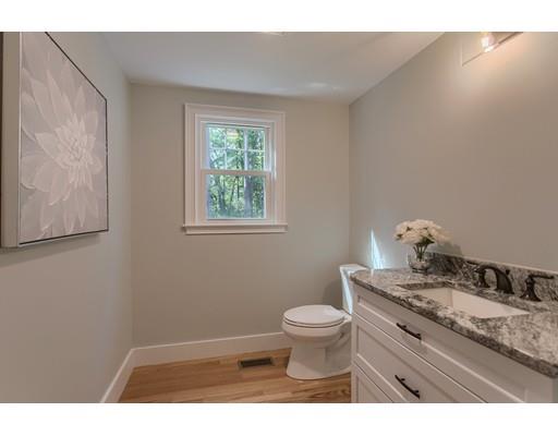 281 Hunters Ridge Road Concord, MA 01742 - Photo 5 of 26 a bathroom with a granite countertop toilet a sink and mirror