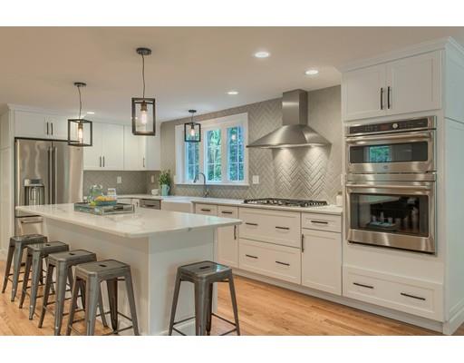 281 Hunters Ridge Road Concord, MA 01742 - Photo 7 of 26 a kitchen with kitchen island granite countertop a stove a sink and a refrigerator